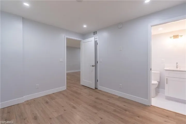 Light wood-finish flooring with white baseboards throughout