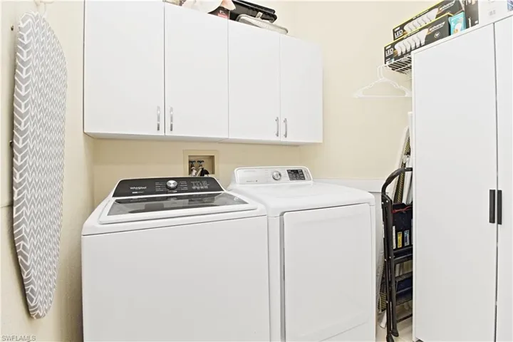 Laundry room featuring washing machine and dryer and cabinet space
