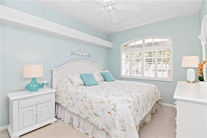 Bedroom featuring light carpet and ceiling fan