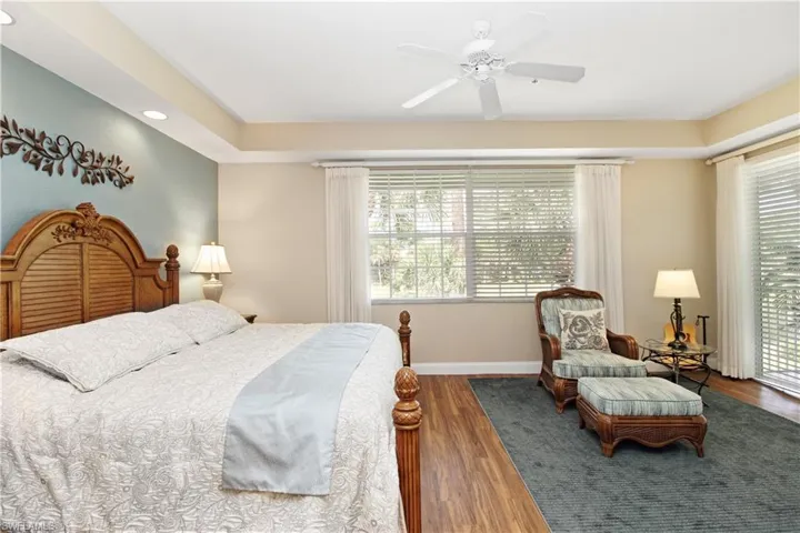 Bedroom with wood finished floors, a ceiling fan, and recessed lighting