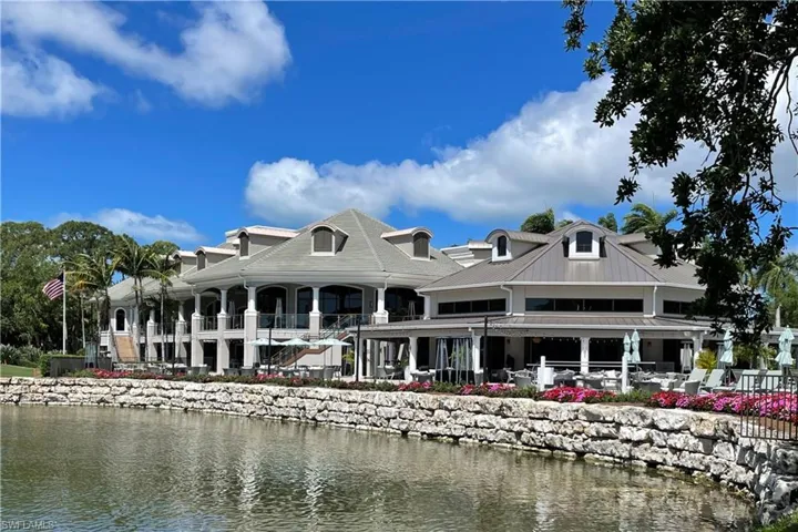 Back of property with a water view and a metal roof