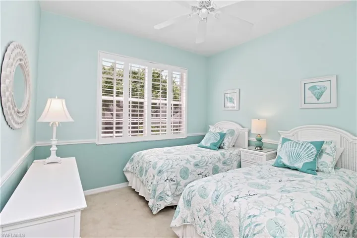 Bedroom with light carpet and ceiling fan