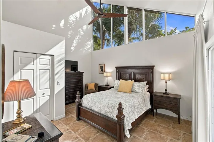 primary suite's stunning window wall creates a serene treehouse feel!