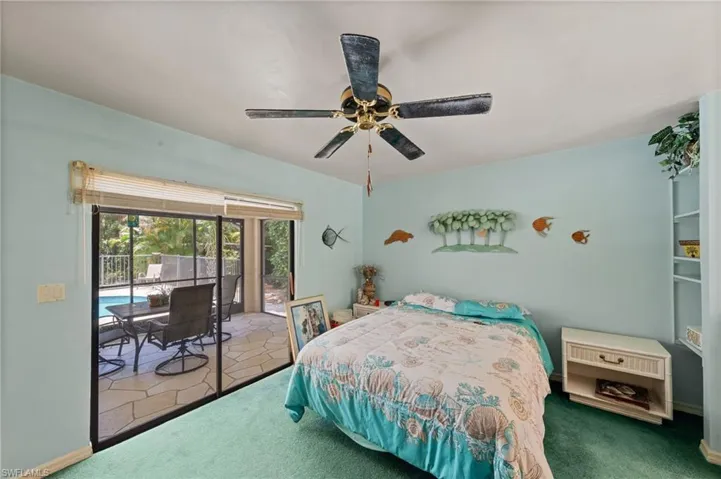 Sliding glass doors opening to a screened lanai with a swimming pool