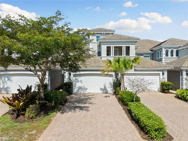 View of front of property featuring driveway, stucco siding, and a garage