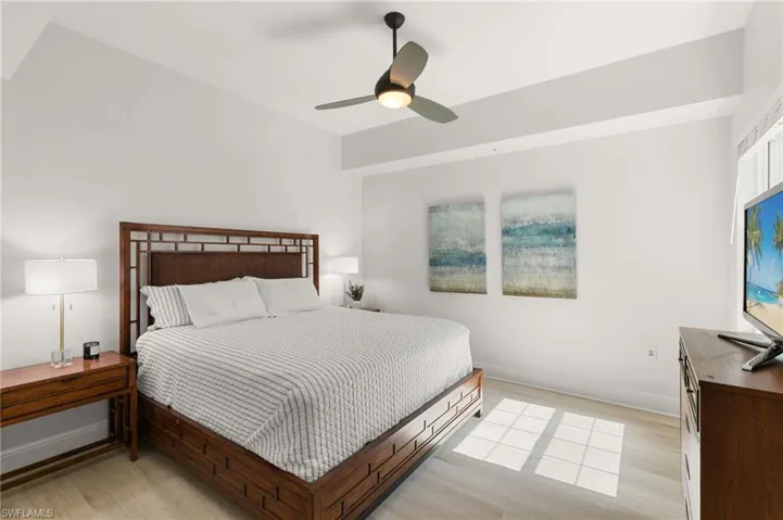 Bedroom with light wood-style floors and ceiling fan