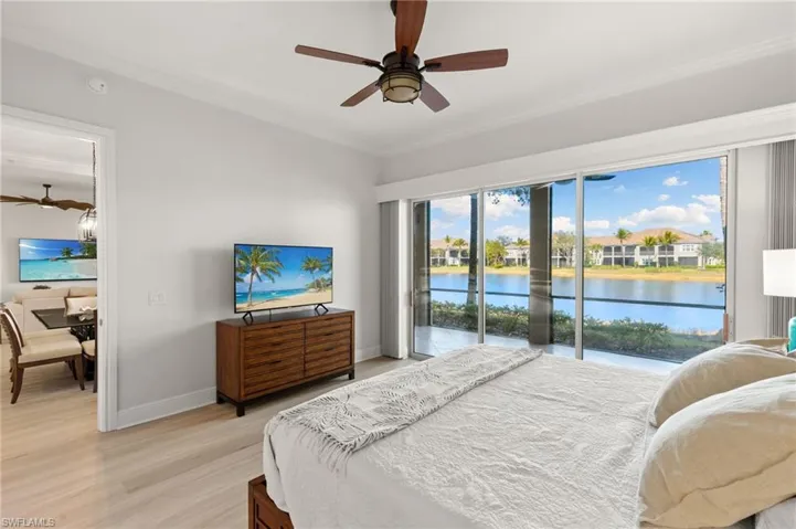Bedroom featuring access to exterior, light wood-style flooring, ornamental molding, and a ceiling fan