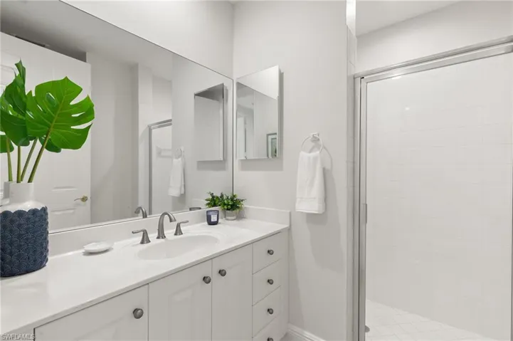 Full bathroom with a stall shower and vanity
