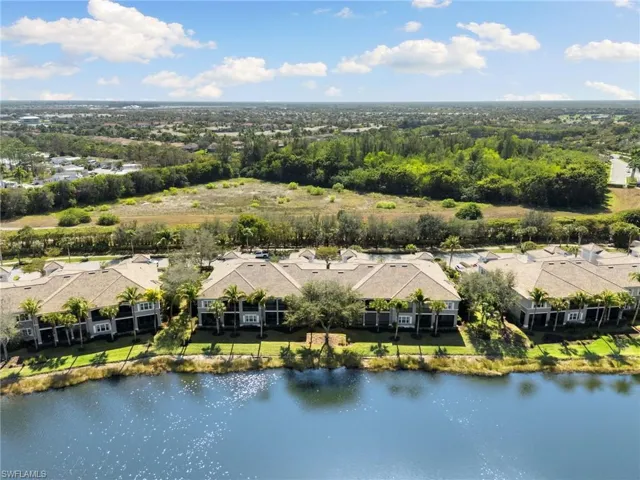 Aerial view of residential area featuring a large body of water