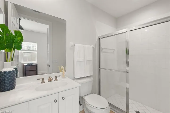 Bathroom with vanity and a stall shower