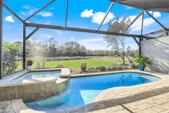 View of swimming pool featuring an in ground hot tub and a patio