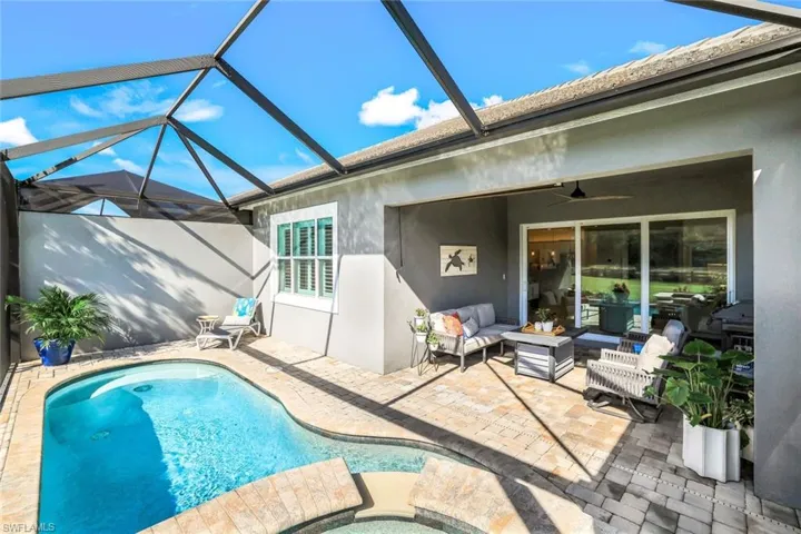 View of swimming pool with a lanai, ceiling fan, a patio area, and an outdoor living space