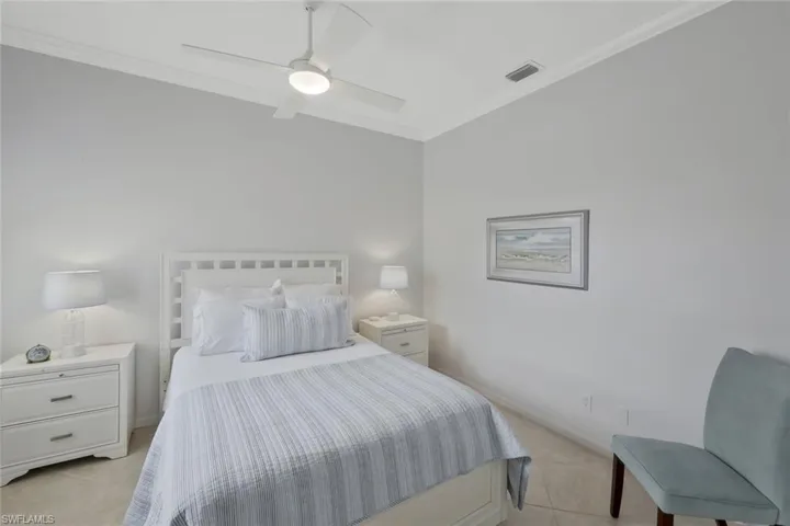 uest bedroom with high ceilings and abundant natural light creating a welcoming retreat for visitors.
