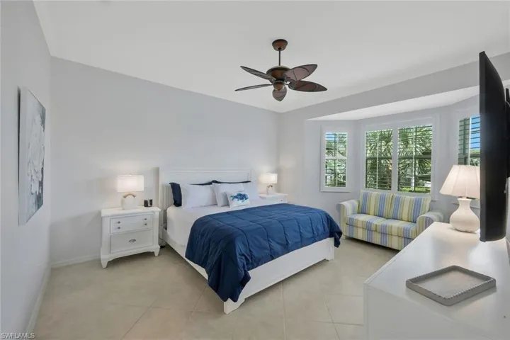 Spacious primary suite with high ceilings, large windows, and private access to the lanai for peaceful morning views.