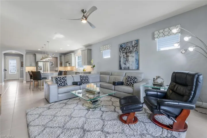 Living room featuring ceiling fan and light tile patterned floors