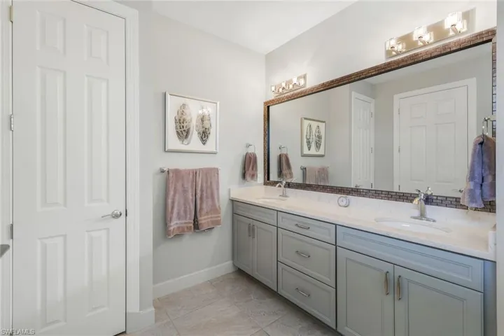 Bathroom featuring tile patterned flooring and double vanity