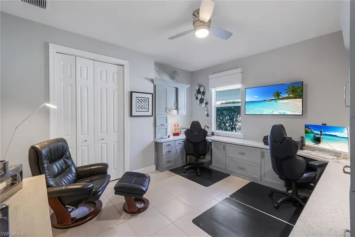 Tiled home office featuring ceiling fan