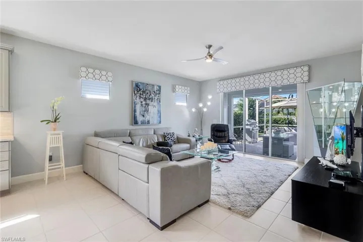 Tiled living room featuring ceiling fan