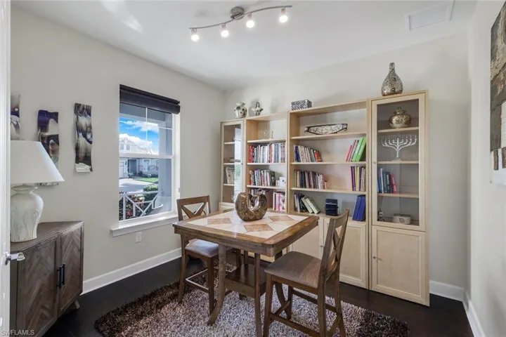 Dining room featuring rail lighting and dark wood-type flooring