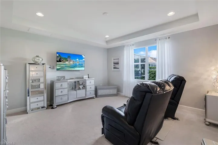 Carpeted living room featuring a raised ceiling