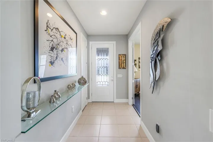 Doorway with light tile patterned floors