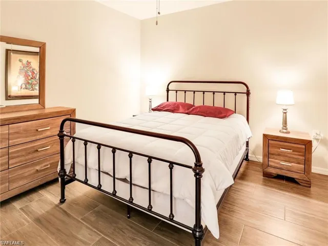 Bedroom with hardwood / wood-style floors