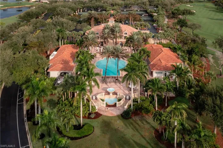 Aerial view of a golf course and a nearby body of water