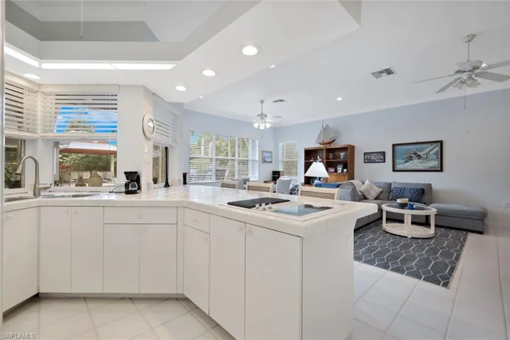 Kitchen with white cabinets, plenty of natural light, and ceiling fan