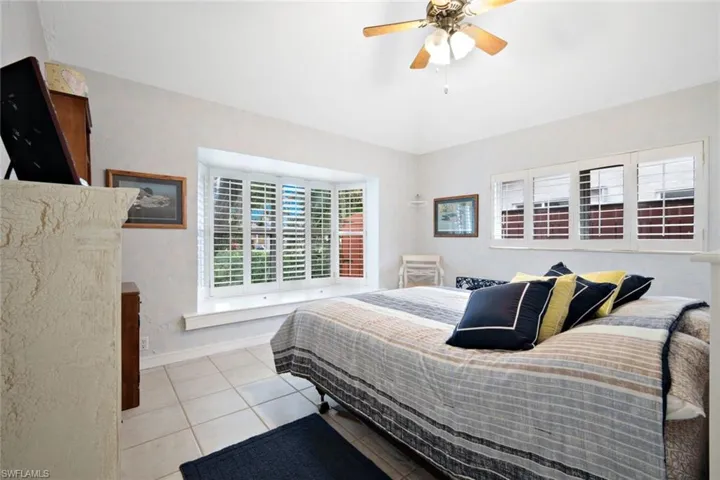 Tiled bedroom with ceiling fan