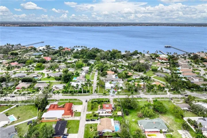 Birds eye view of property with a water view