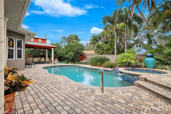 View of pool with an in ground hot tub and a patio area