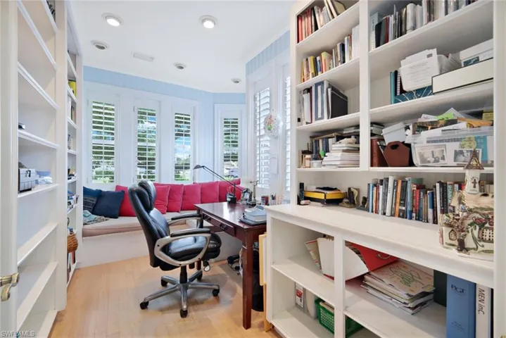Office space featuring crown molding and light hardwood / wood-style flooring