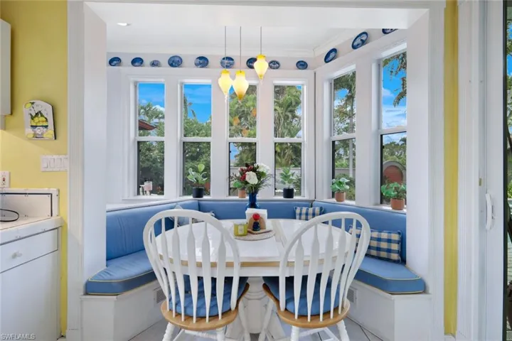 Tiled dining space featuring ornamental molding, breakfast area, and a healthy amount of sunlight