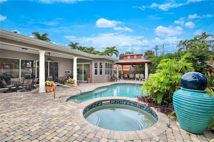 View of pool with a patio, a gazebo, and an in ground hot tub