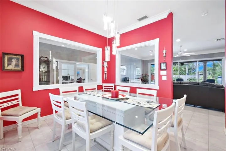 Tiled dining space featuring crown molding and ceiling fan