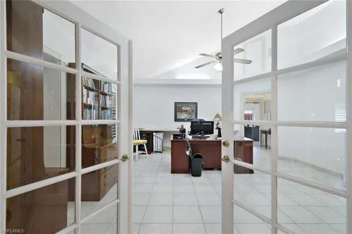 Office space featuring light tile patterned flooring, french doors, and ceiling fan