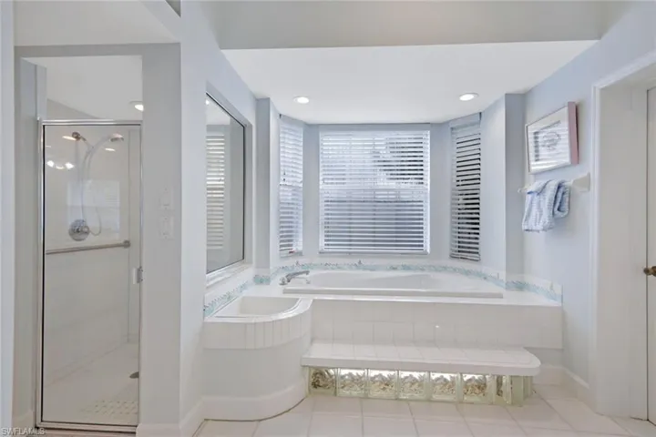 Bathroom with plus walk in shower, tile patterned flooring, and a healthy amount of sunlight