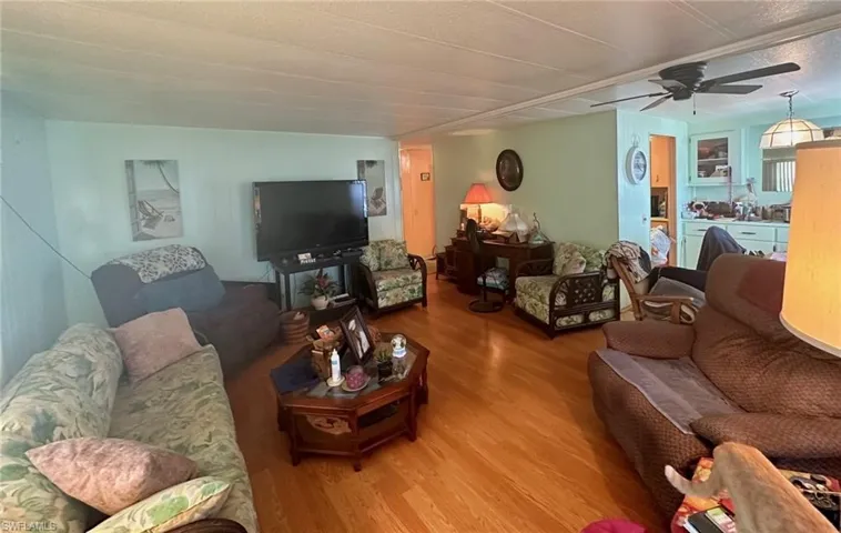 Living area with dining area to the right of the photo.