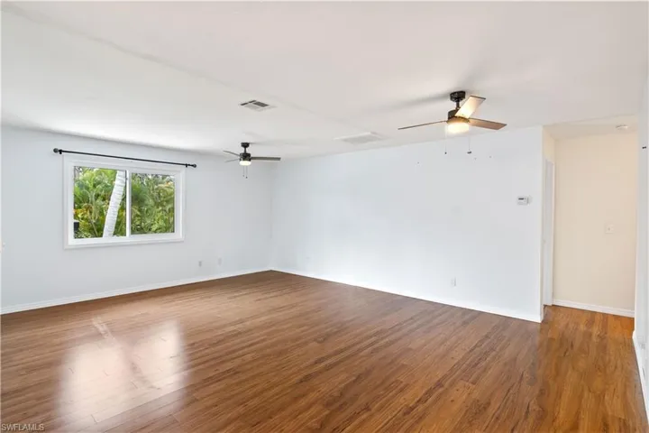 Living room with neutral and soothing paint palette!  Lots of natural light and plenty of room to hang large pieces of art!