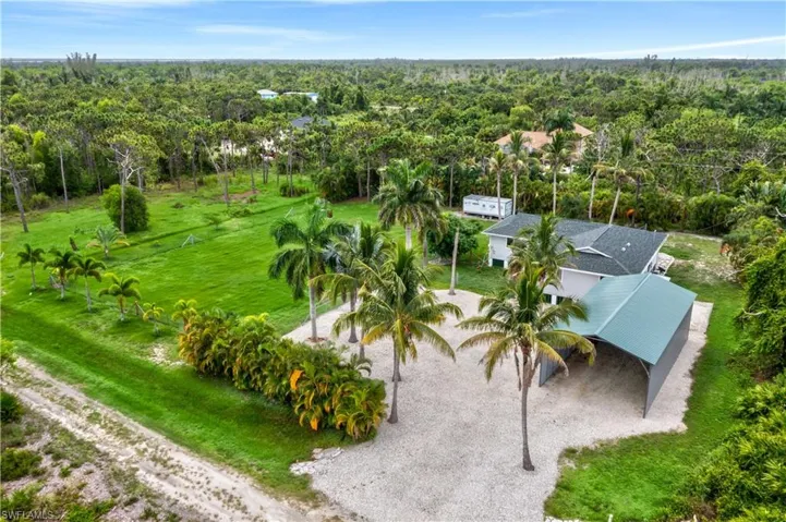 South facing backyard is perfect to enjoy the beautiful sunshine.  HUGE oversized driveway can easily accommodate multiple cars and as an added bonus the metal building could be converted into closed space - whether it is a garage or workshop, there are so many additional options!