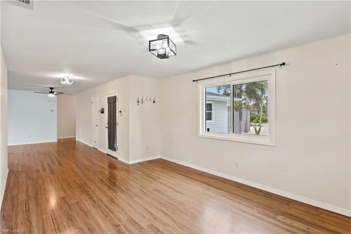 Dining room with chandelier and plenty of room for larger dining tables and china cabinet.