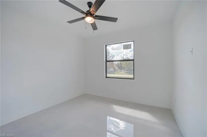Spare room featuring ceiling fan and light tile patterned flooring