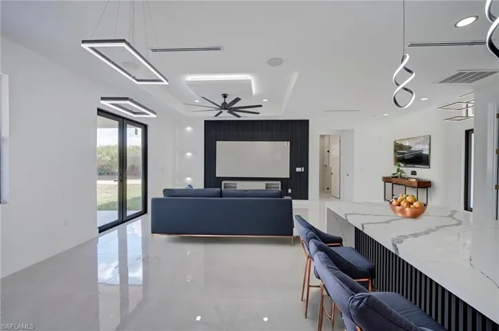 Living area with a ceiling fan and recessed lighting