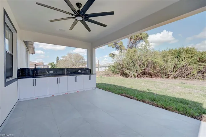 View of patio featuring a ceiling fan and an outdoor kitchen