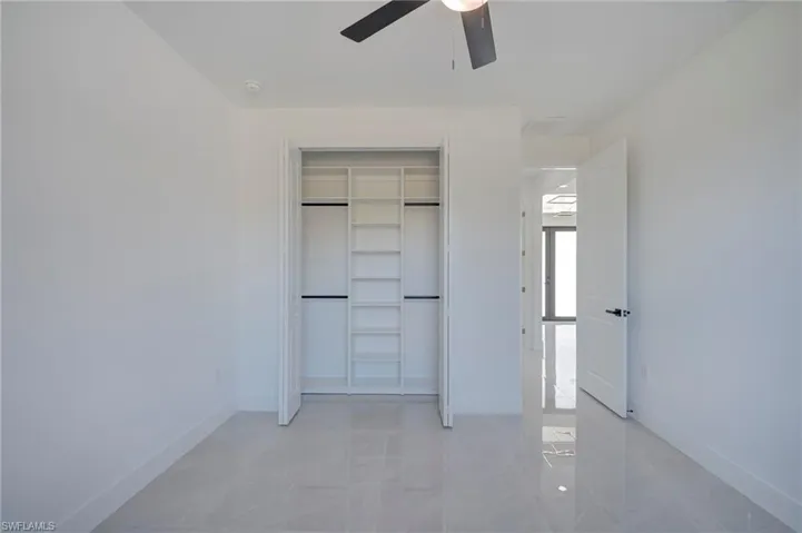 Unfurnished bedroom featuring a closet and ceiling fan