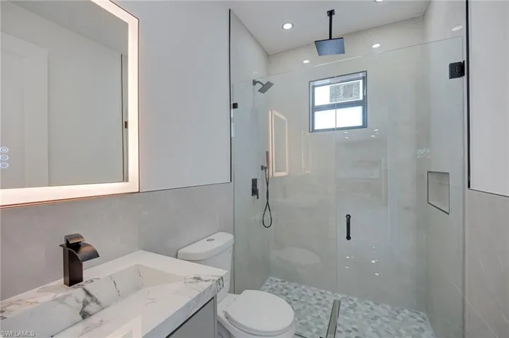Bathroom featuring vanity and a shower stall