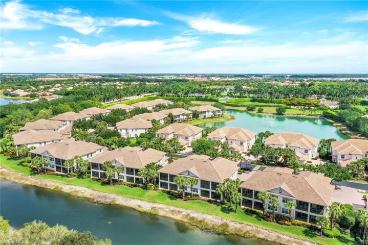 Community of residences with screened balconies overlooking water features and mature landscaping