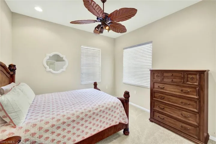 Vaulted ceiling with recessed lighting and a ceiling fan featuring leaf-shaped blades