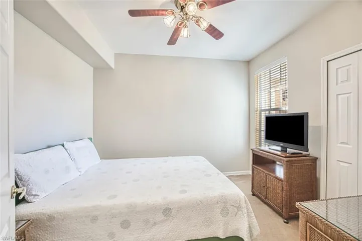 Bedroom featuring light colored carpet and ceiling fan