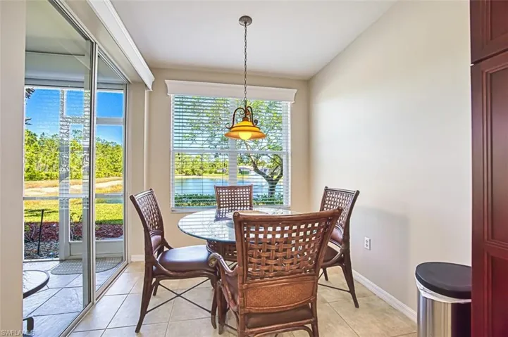 Dining space with light tile patterned flooring and a water view